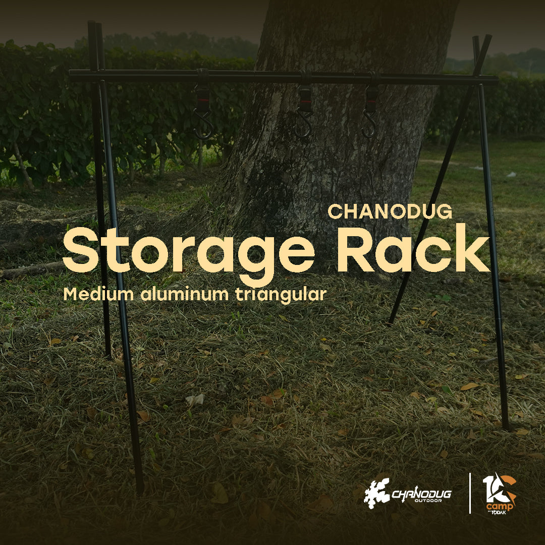 A medium aluminum triangular storage rack with the brand name CHANODUG written on it, placed outdoors on a grassy area near a tree.