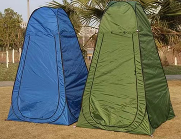 Two changing tents, one blue and one green, standing outdoors.
